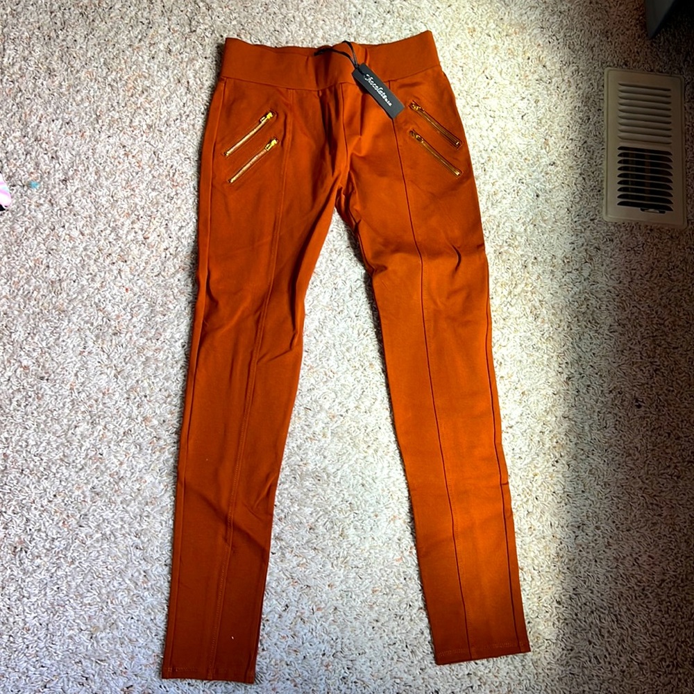 Cute stretchy pants with gold zipper pockets.